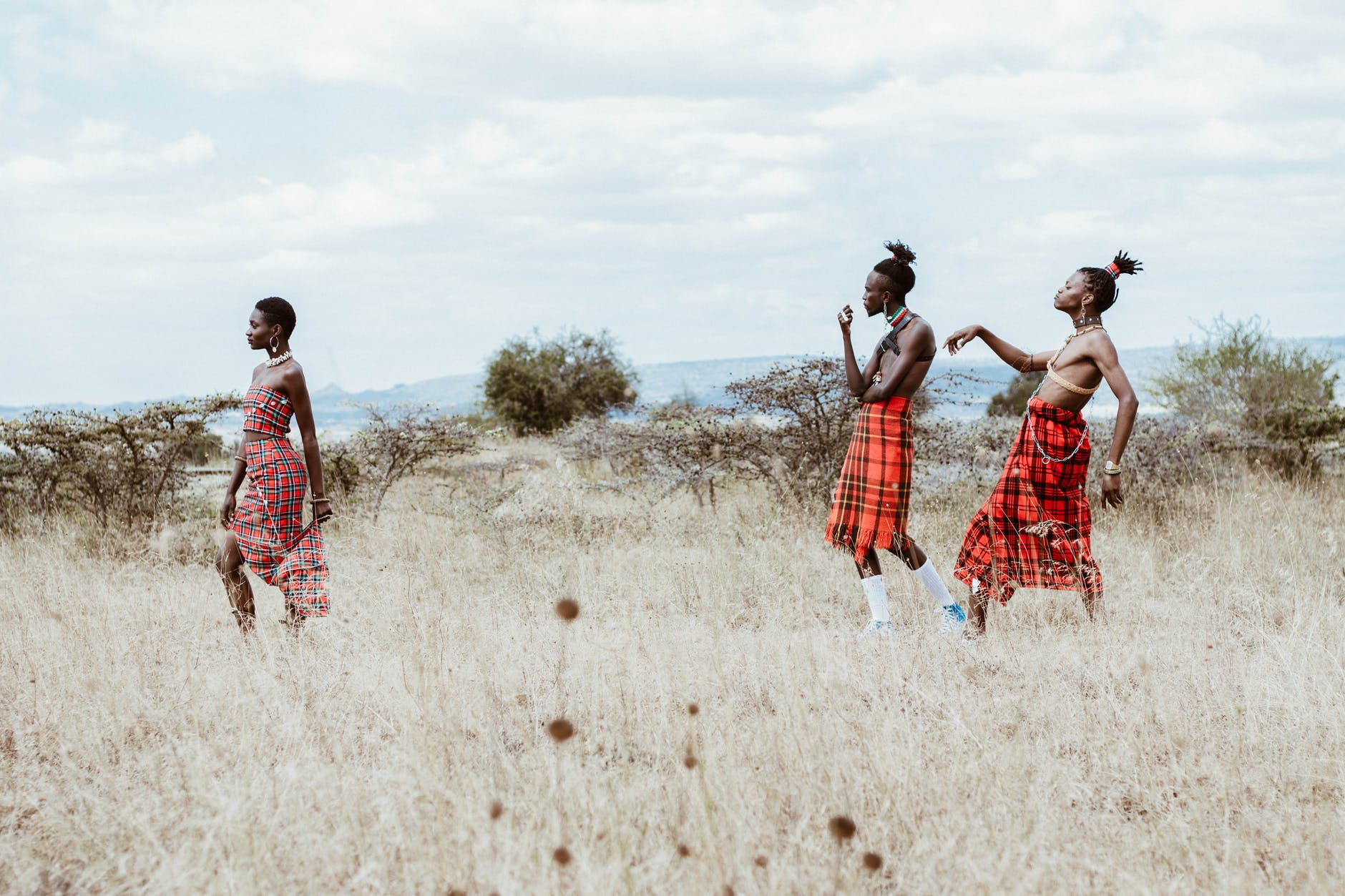 photo of people walking on grassland