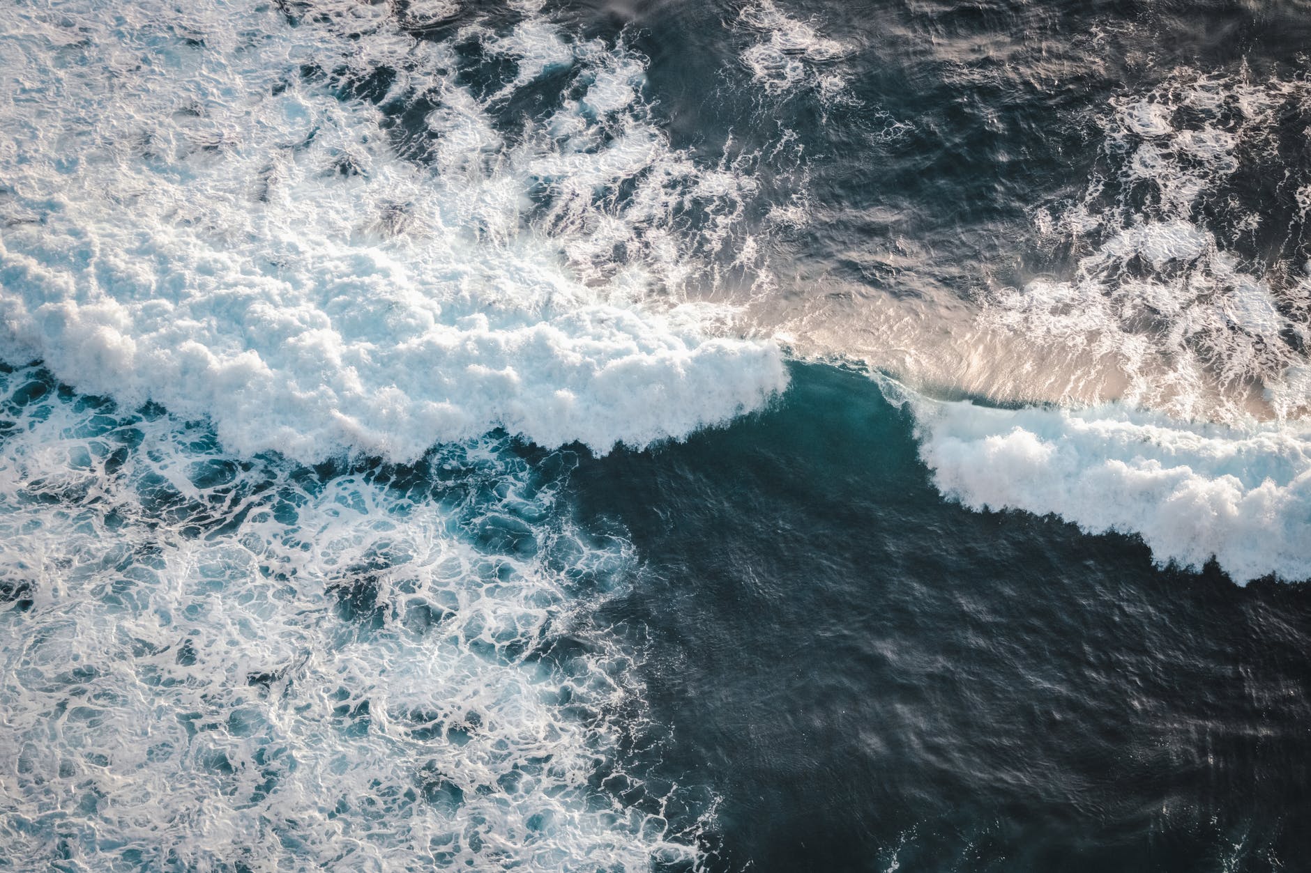 stormy ocean with foamy waves in daylight