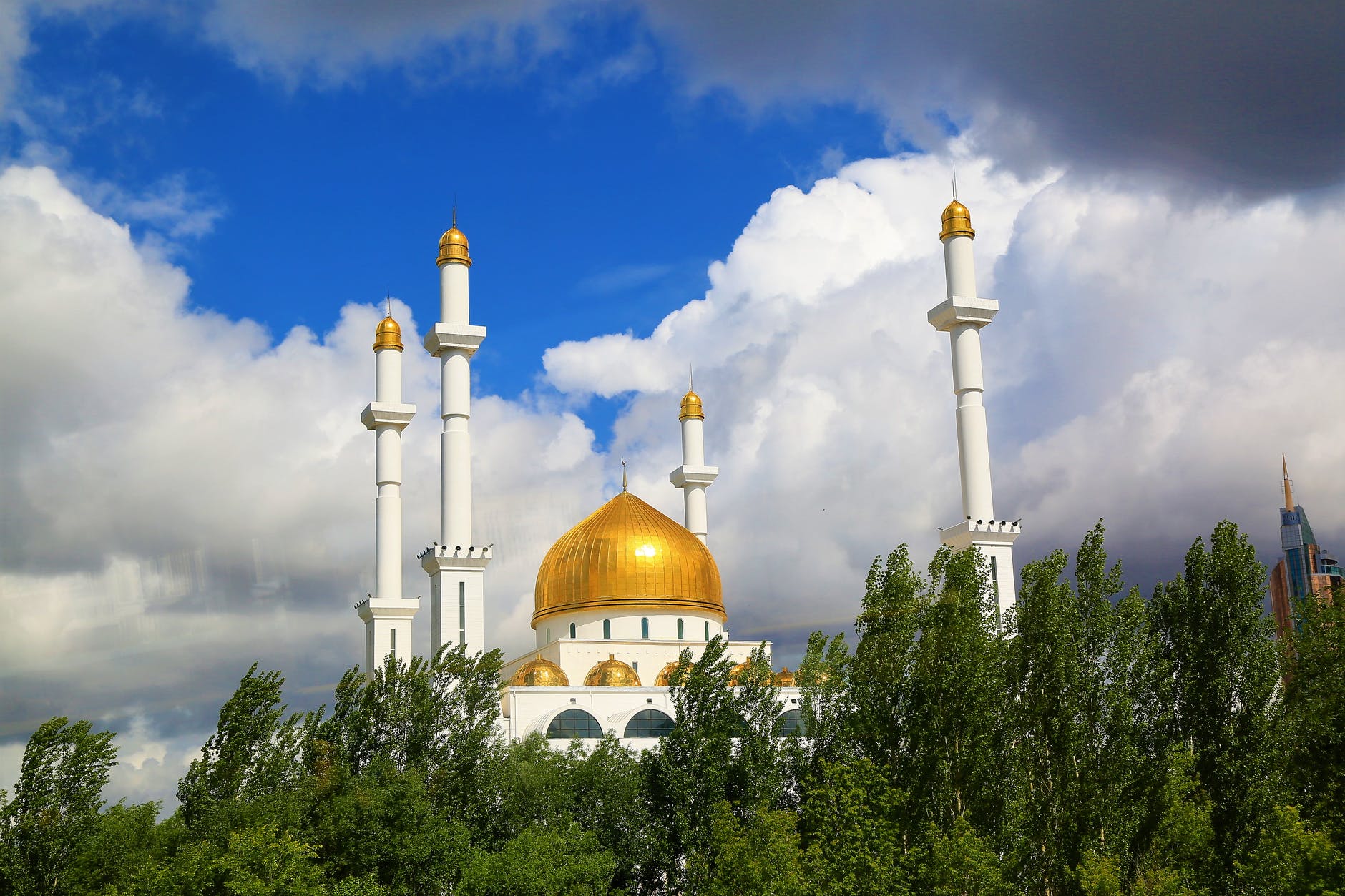 photo of mosque under cloudy sky